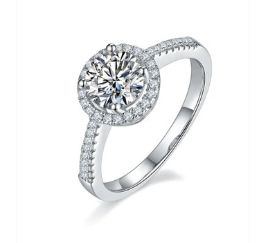 1Ct Round Brilliant Moissanite Solitaire With A Halo And Shoulder Stones