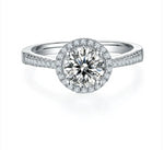 1Ct Round Brilliant Moissanite Solitaire With A Halo And Shoulder Stones